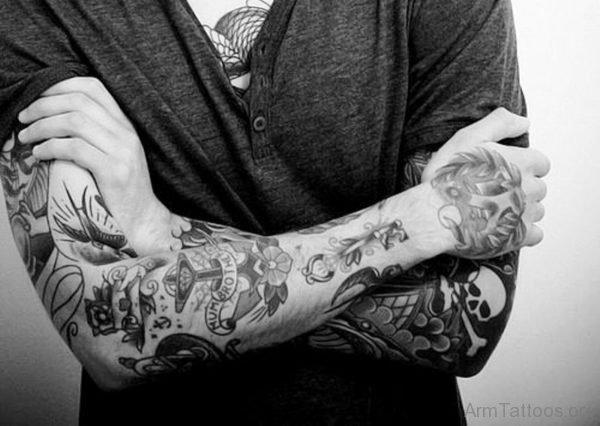 Adorable Black Flowers Tattoo On Arm 