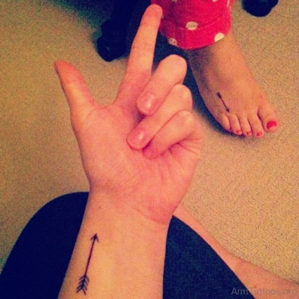 Black Colored Arrow Tattoo On Arm For Girls