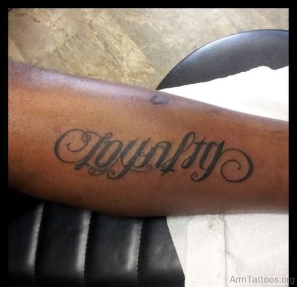 Black Ink Loyalty Ambigram Tattoo On Arm