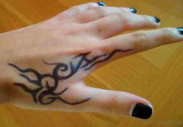 Black Ink Tribal Tattoo On Top Of Hand