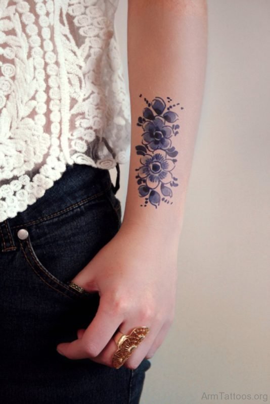 Blue Ink Lotus Flower Tattoo On Arm