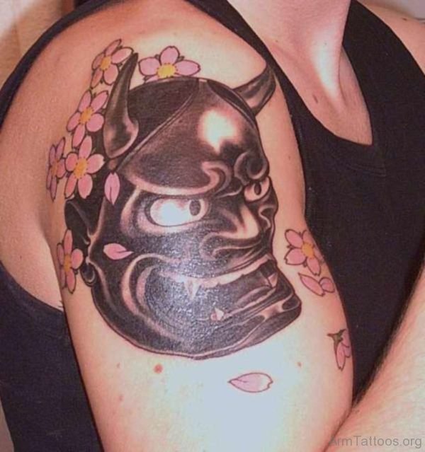 Dark Black Hannya Mask And Blossoms Tattoos On Biceps