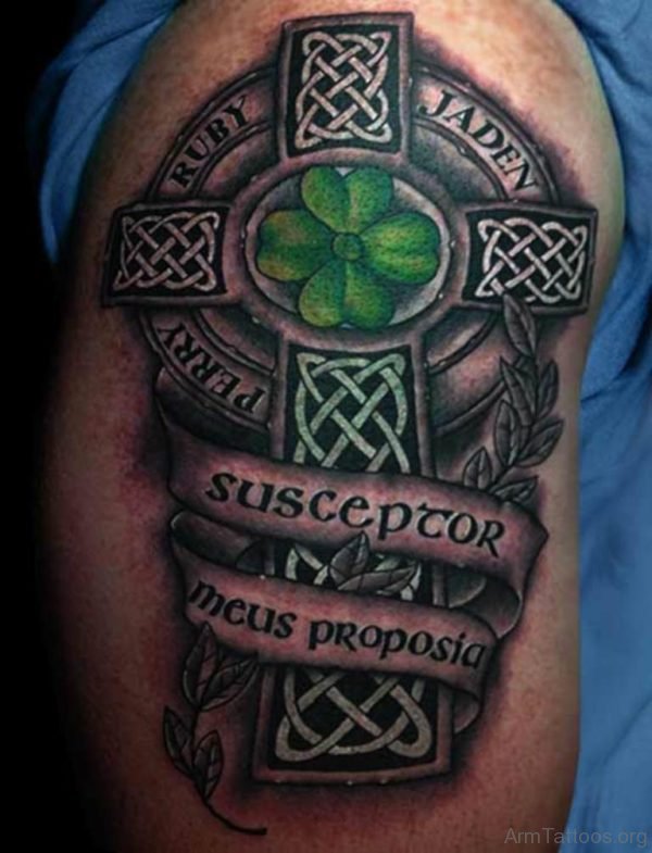 Green Clover Leave In Celtic Cross With Banner Tattoo On Arm 