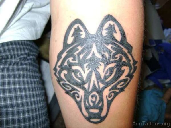 Grey Ink Tribal Wolf Tattoo On Arm