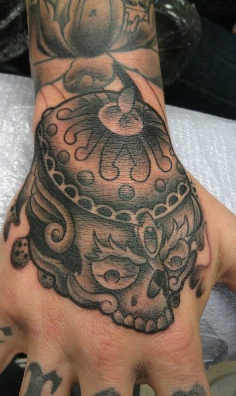 Grey Tibetan Skull Tattoo On Hand