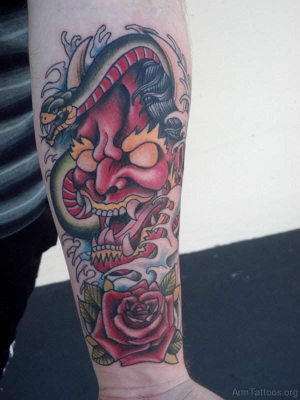 Japanese Mask And Snake Tattoos On Lower Arm