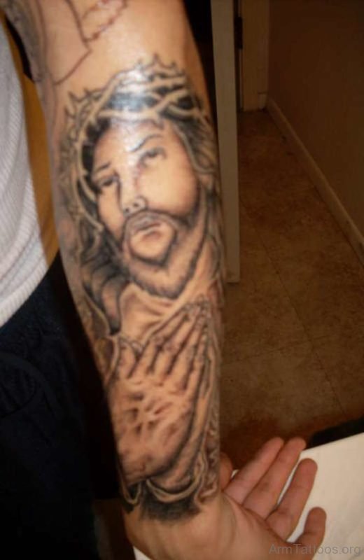 Jesus Face And Praying Hands Tattoo On Arm