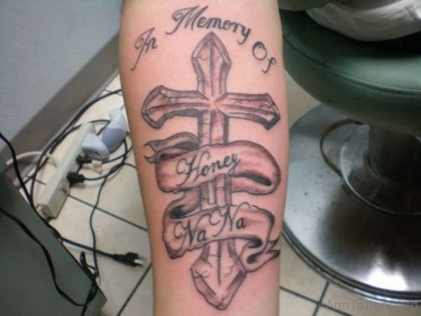 Memorial Cross And Names Tattoos On Lower Arm