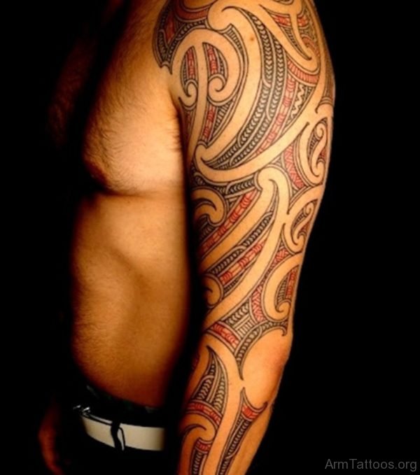 Red And Black Ink Tribal Tattoo On Chest