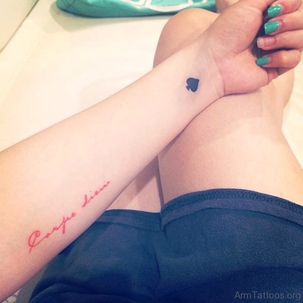 Red Ink Carpe Diem Tattoo On Arm 