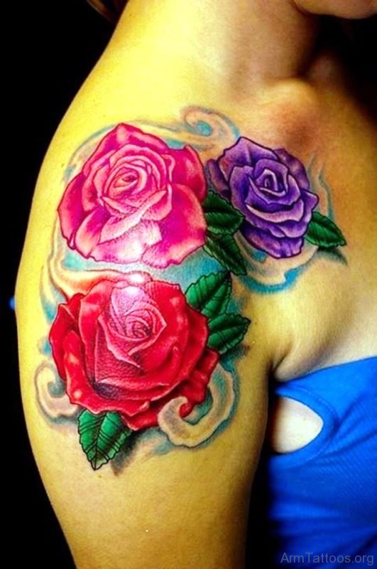 Red Pink And Magenta Flower Tattoo On Arm 