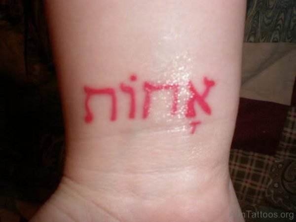 Red Words Tattoo On Wrist