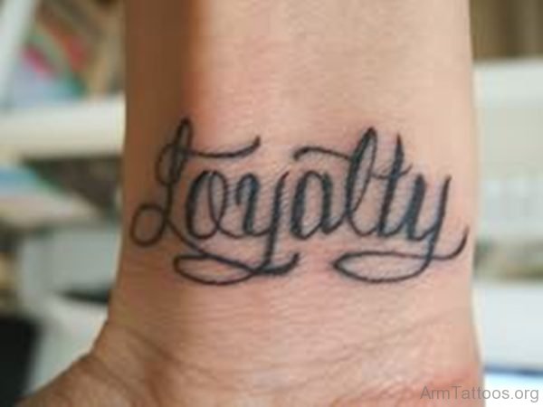Small Loyalty Ambigram Tattoo On Wrist