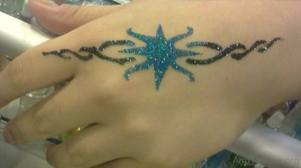 Star And Tribal Glitter Tattoo On Hand