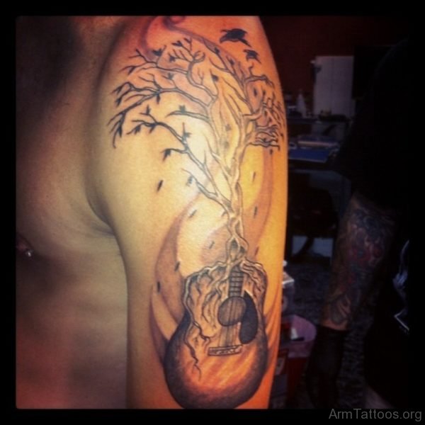 Tree Shaped Head Guitar Tattoo On Shoulder For Men