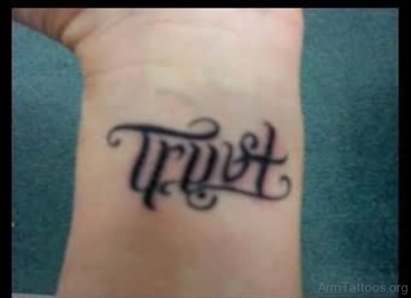 Trust Ambigram Tattoo On Wrist