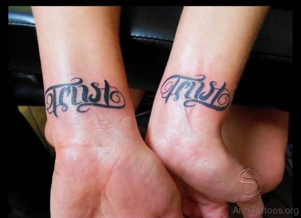 Trust Ambigram Tattoo On Wrist For Couple