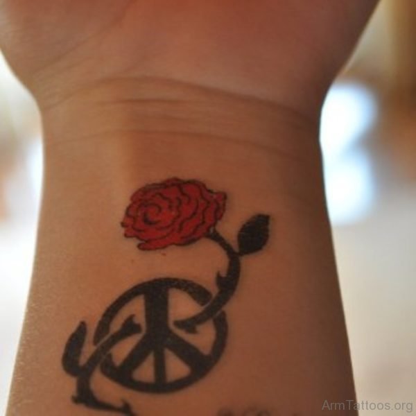 Wheel And Rose Tattoo On Wrist 
