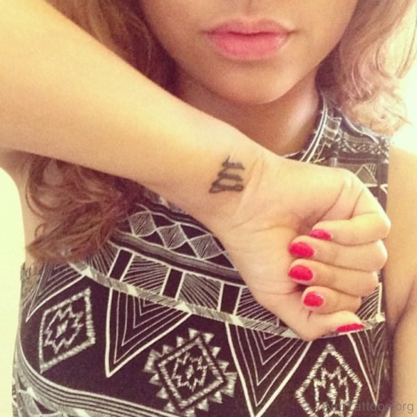 Black Ink Virgo Tattoo On Wrist Image